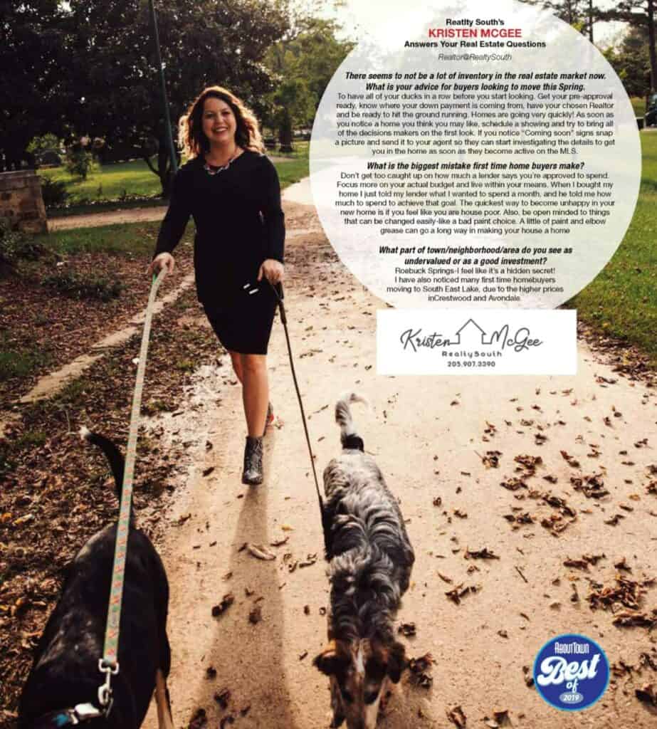 Woman walking dogs in a park during autumn, smiling and enjoying the day.