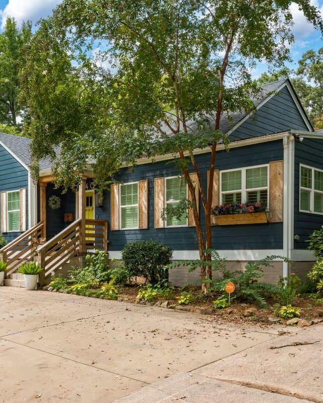 Bright blue house with large windows and a front porch.