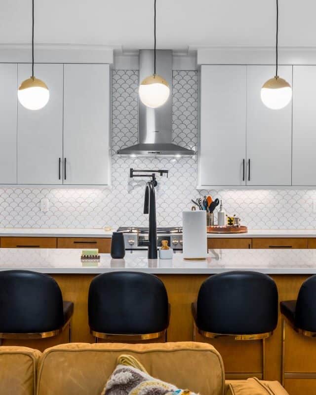 Modern kitchen with sleek white cabinets and a central island.