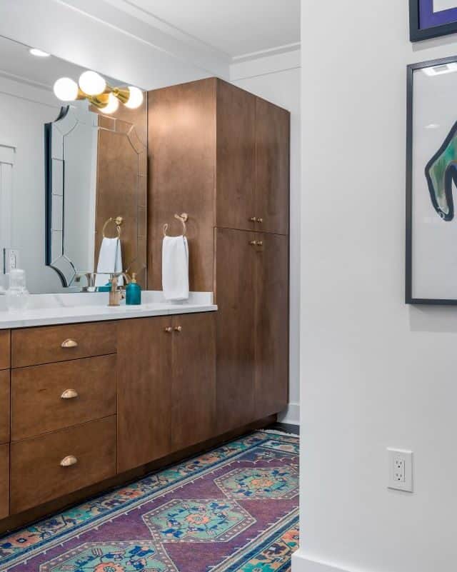 Modern bathroom with wooden vanity and colorful dog art wall decor.