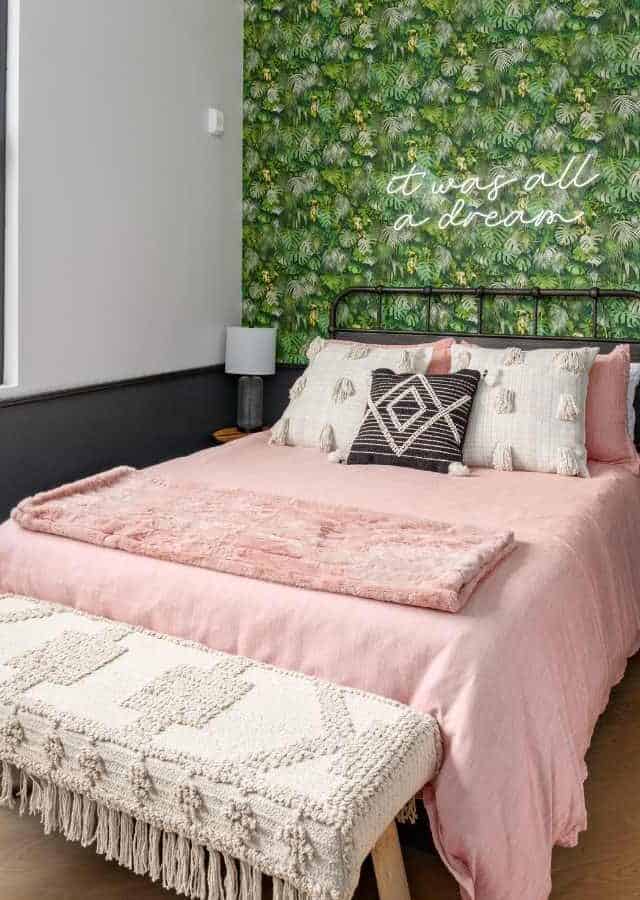 Cozy short-term rental bedroom in Birmingham with green wall decor and stylish furnishings.
