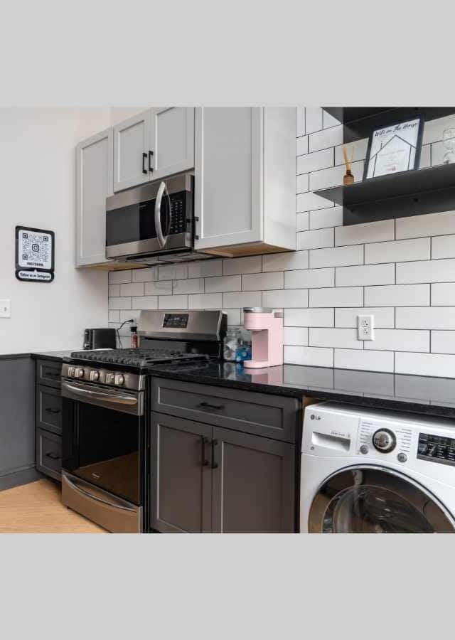 Contemporary kitchen with appliances in Birmingham’s Mercantile on Morris.