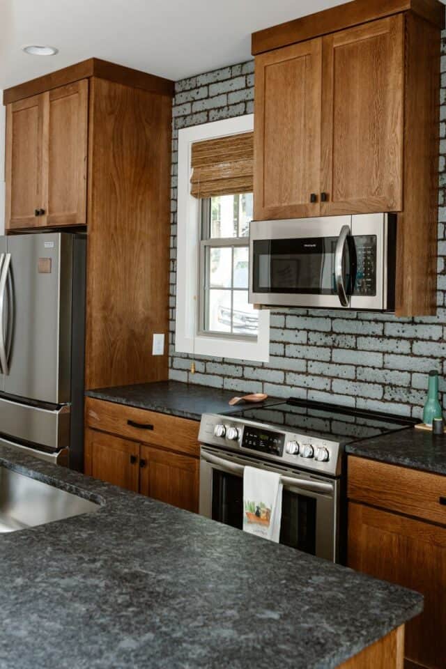 Kristen McGee Interiors modern kitchen with wooden cabinets and stainless steel appliances.