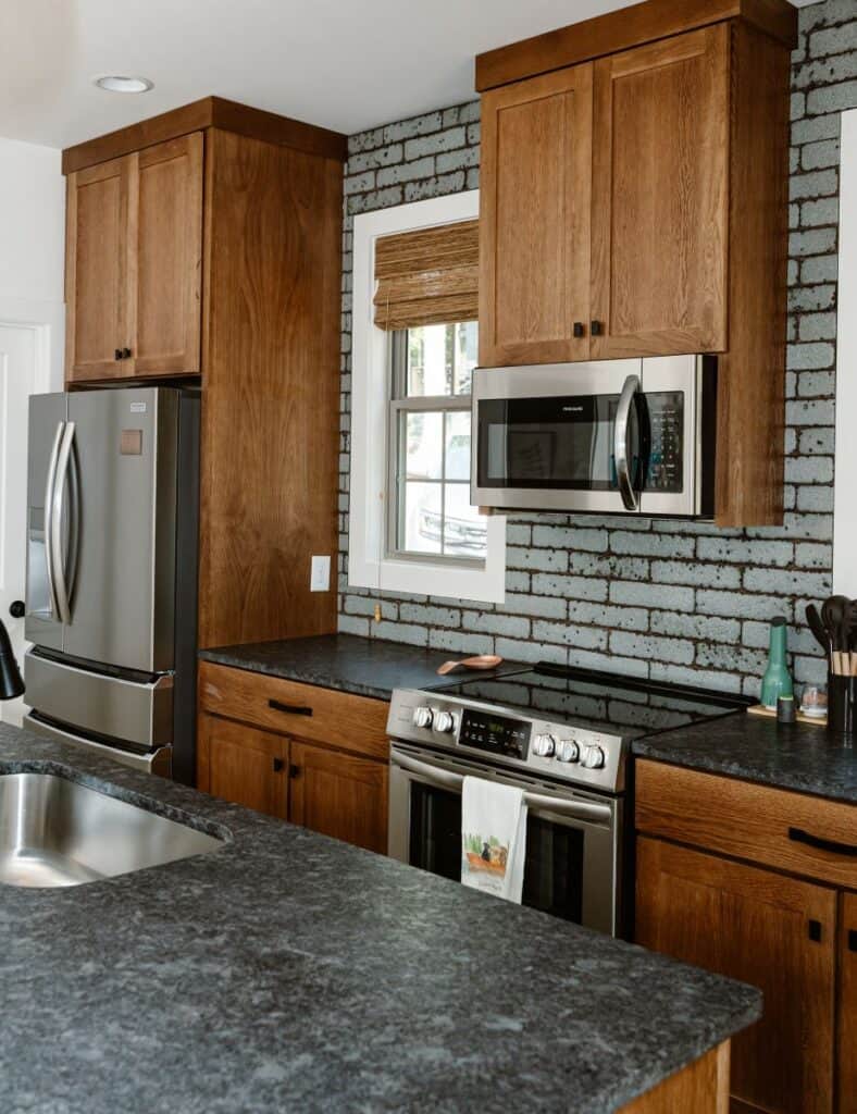 Kristen McGee Interiors modern kitchen with wooden cabinets and stainless steel appliances.