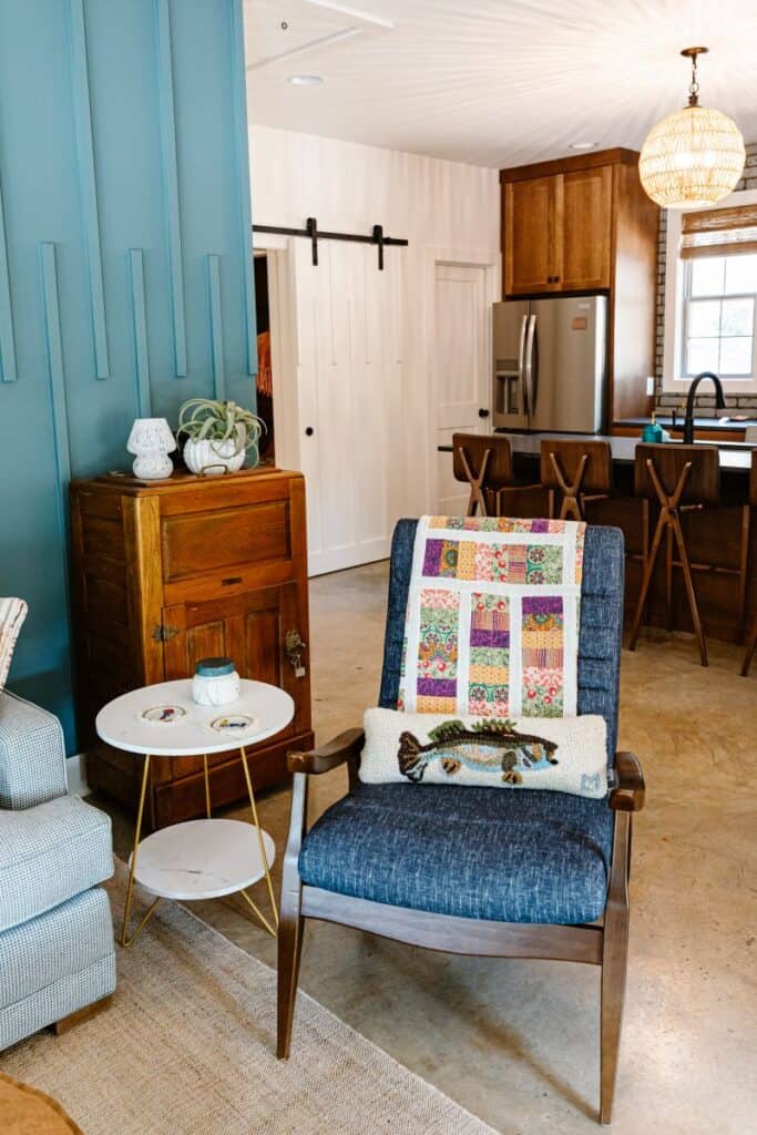 Cozy living room with colorful quilt and modern decor in a Harmony Cove home.