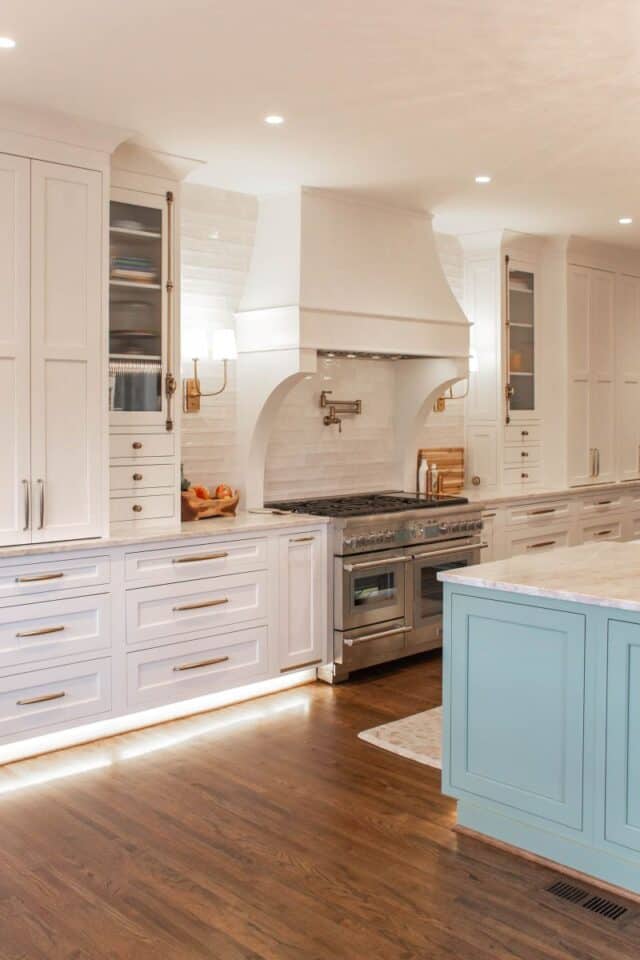 Modern white kitchen with custom cabinetry and a central island.