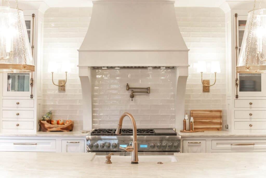 Elegant kitchen featuring a renovated cooking area with a stylish range hood and white cabinetry.