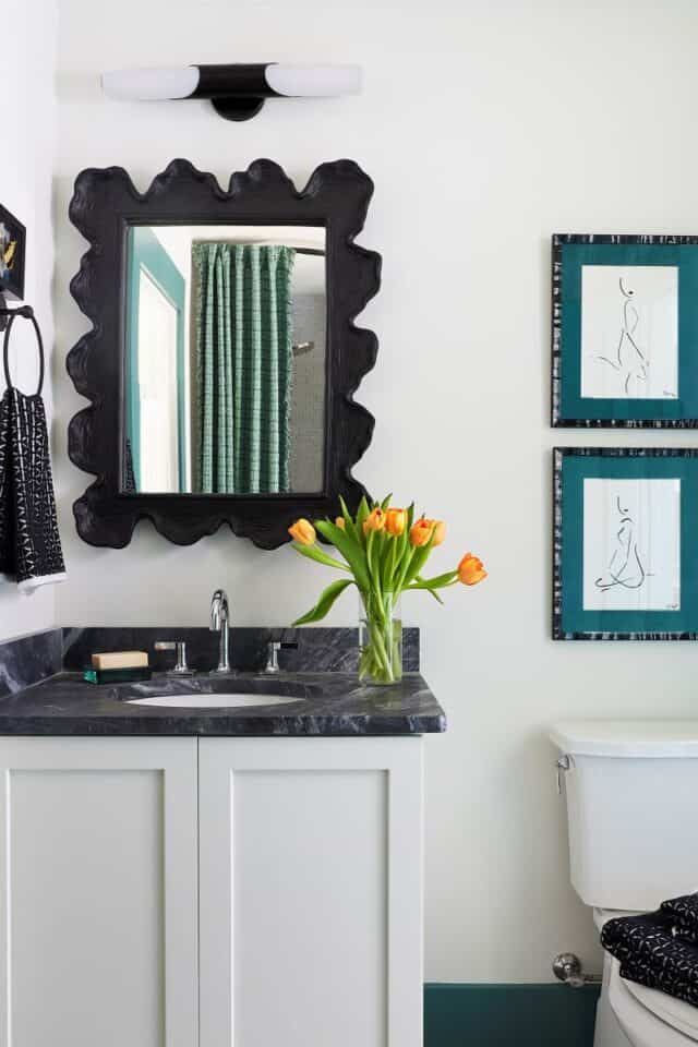 Elegant guest nook with mirror, sink, and decor for modern Birmingham home.