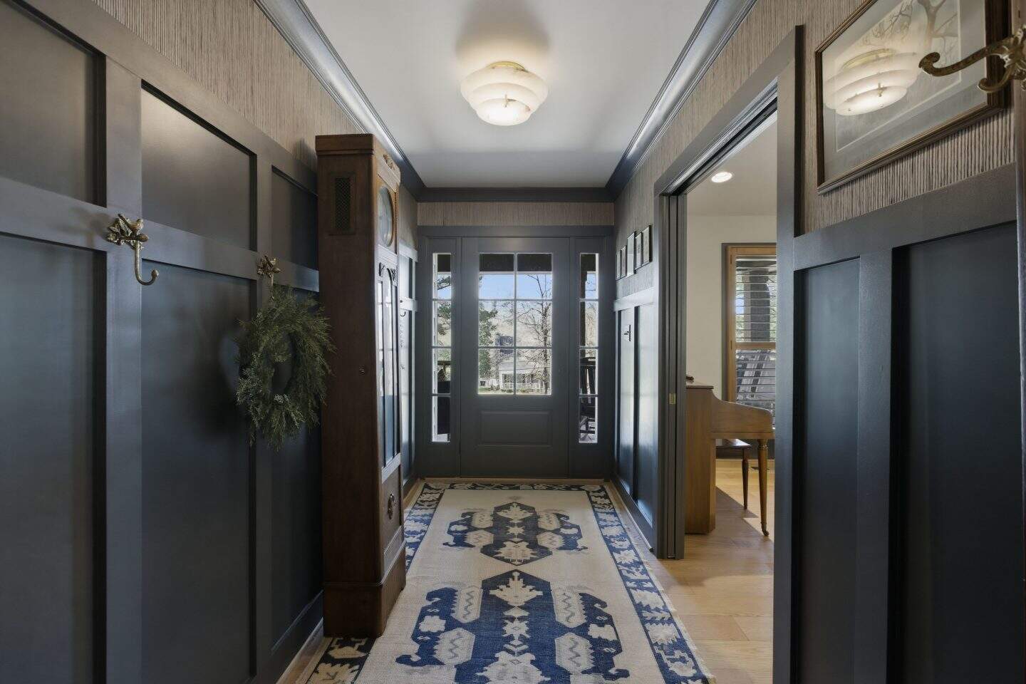 Entryway of a family home in Birmingham, AL with stylish wall paneling and welcoming decor.