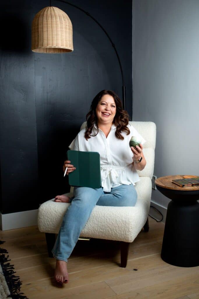 Kristen McGee Interiors logo on a modern, cozy living room setting.