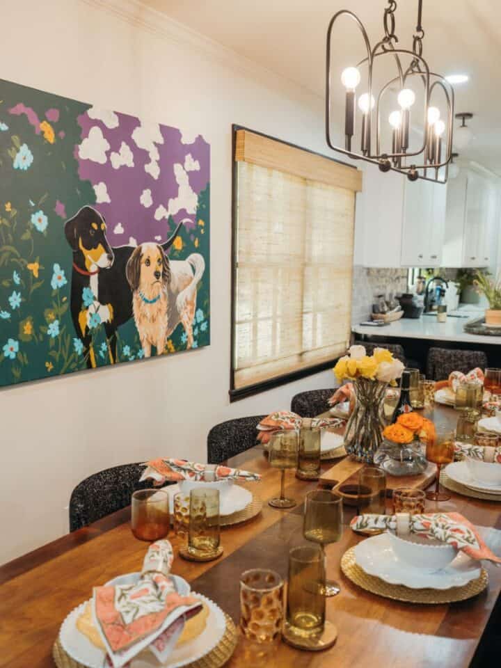 Elegant dining room with artwork, chandelier, and a well-set table for gatherings.