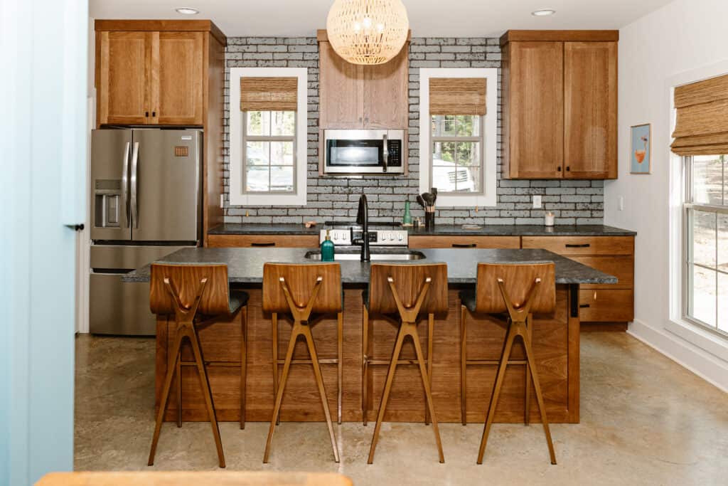 Contemporary lakeside kitchen with wooden cabinets and modern appliances.