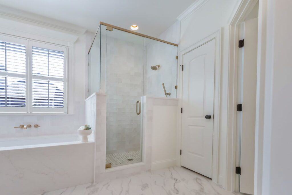 Modern Highland Lakes bathroom with a glass shower enclosure and elegant white finishes.