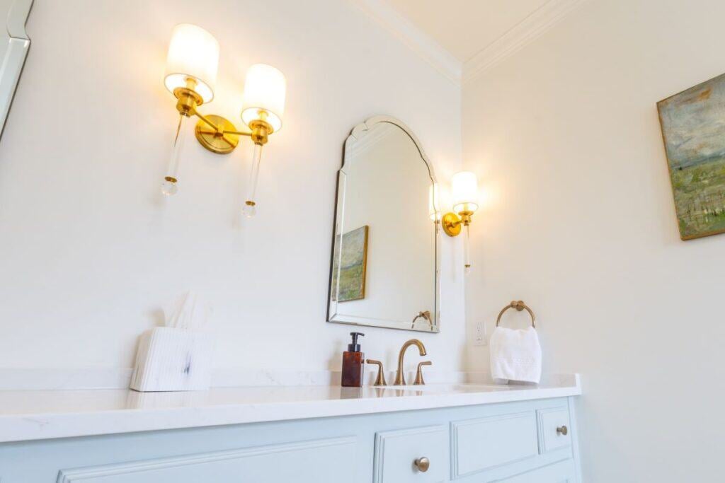 Beautiful Highland Lakes bathroom with elegant lighting and mirror.