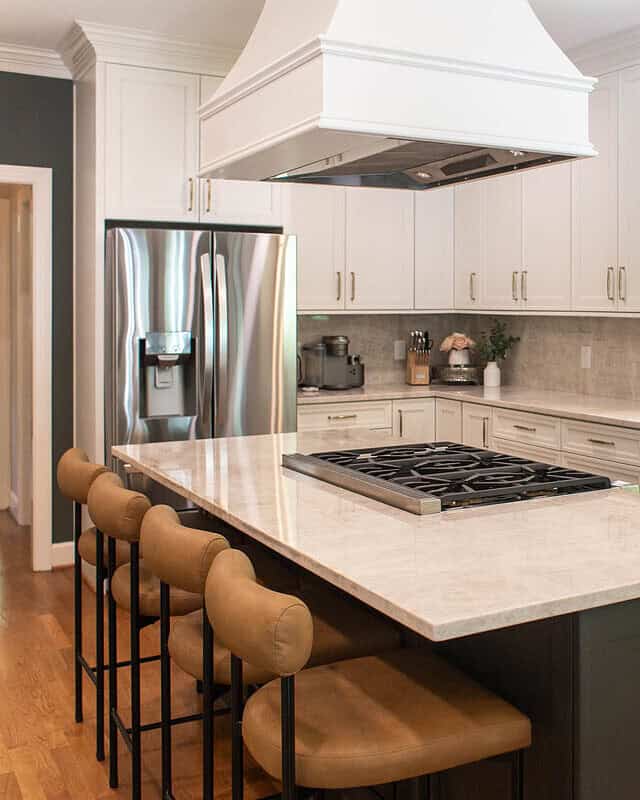 Bright, organized kitchen with white cabinets and stainless steel appliances.