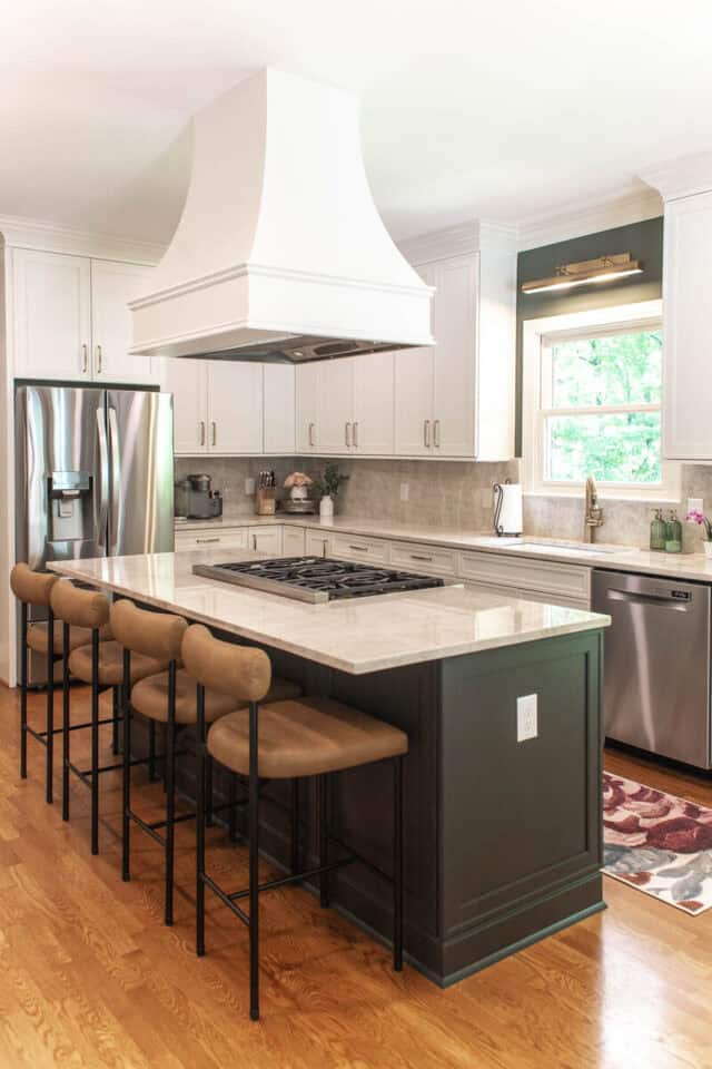 Bright, modern kitchen with island, stainless steel appliances, and natural light.