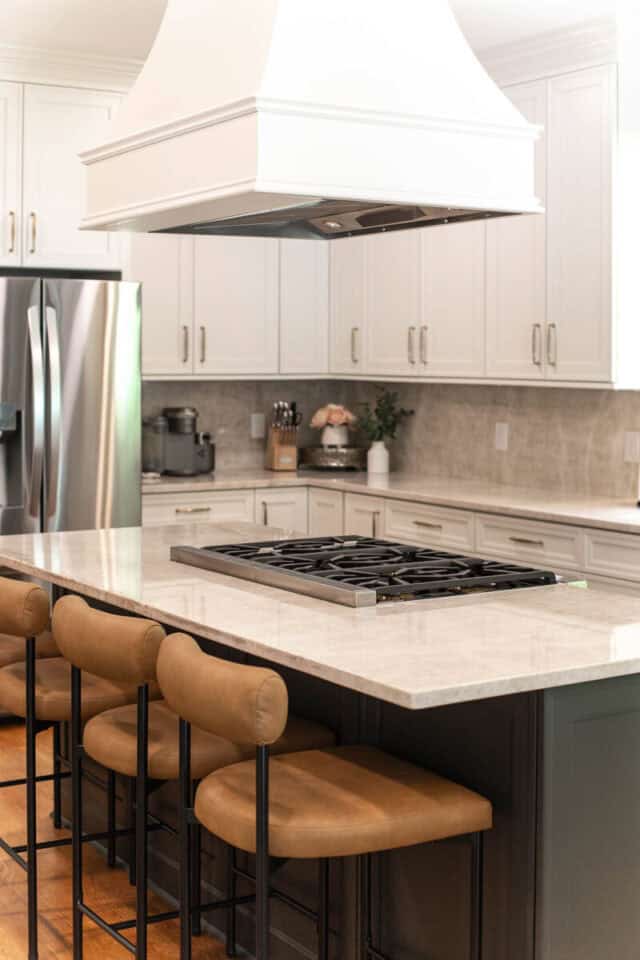 Bright modern kitchen with white cabinets and a central island with seating.