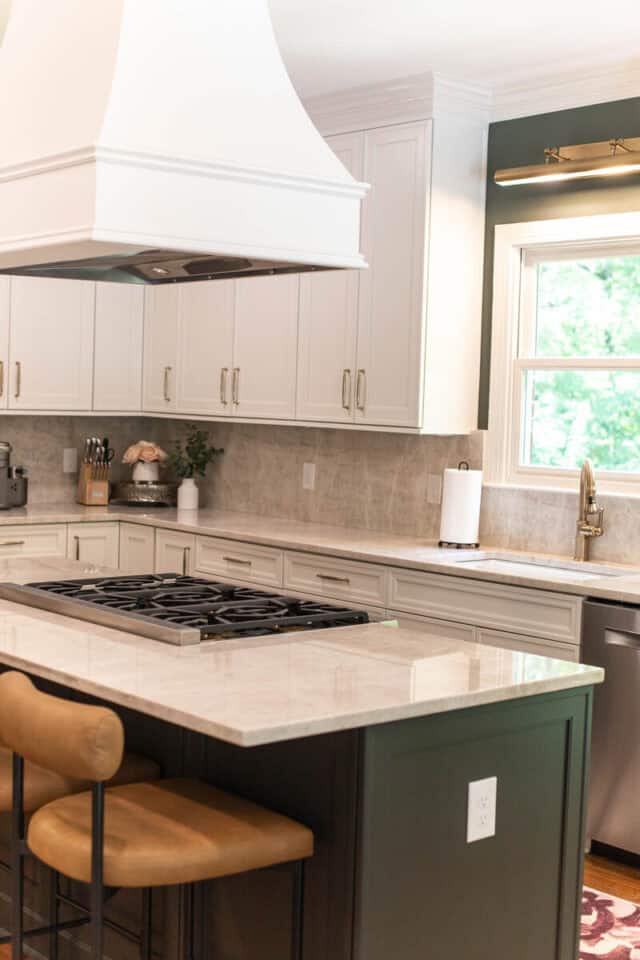 Bright, organized kitchen with white cabinets and a central island.
